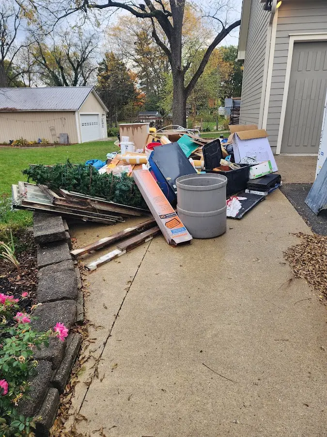 Dumpster being loaded with debris for 12 Yard Dumpster Rental in Boulder Hill